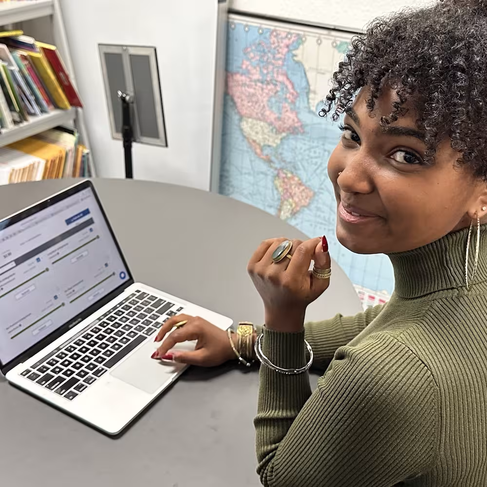A student using a laptop during a college planning session.