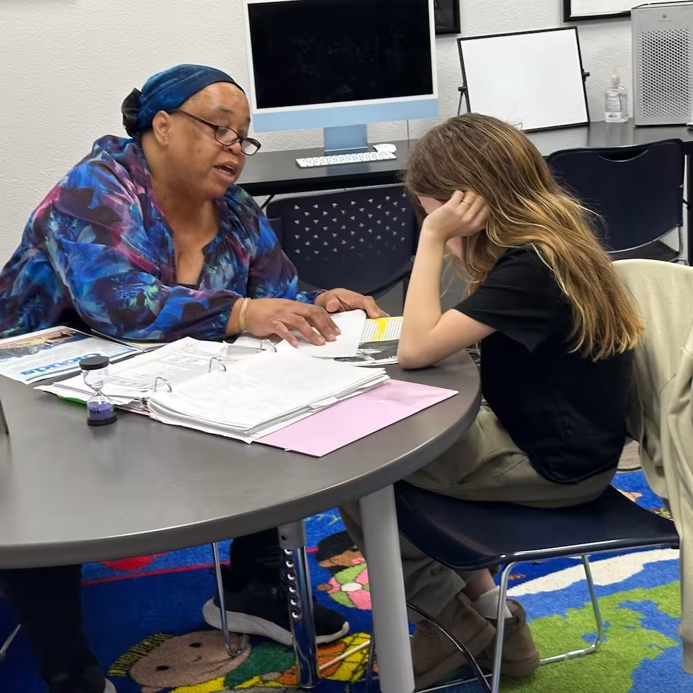 An instructor helping a student during a one-on-one tutoring session.