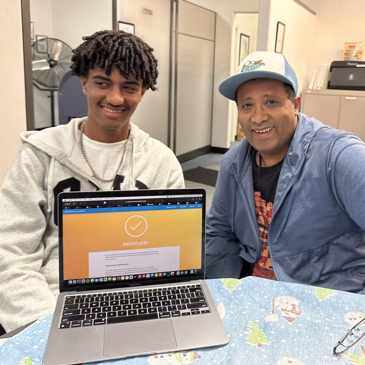 A student and mentor smiling during a college readiness session.